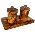 Olive wood canister set with carved storage base for kitchen counter.