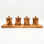 Four olive wood canisters on a long carved base for pantry storage.