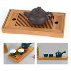 Clay teapot sitting on a slatted bamboo tea tray