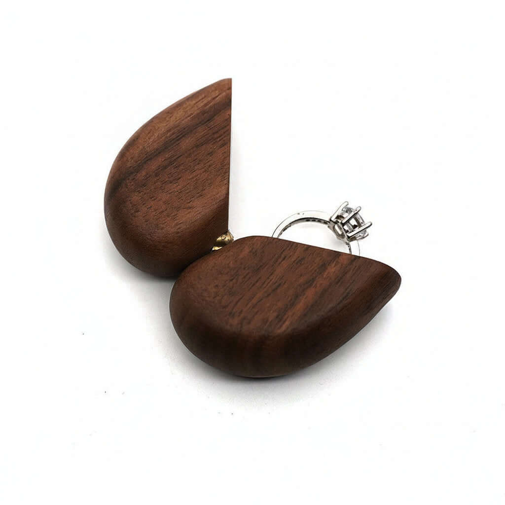Open wooden heart ring box in two halves on white, with a ring beside it for scale — Serein Home