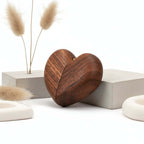 Closed wooden heart ring box leaning on a concrete block with dried bunny tails — Serein Home