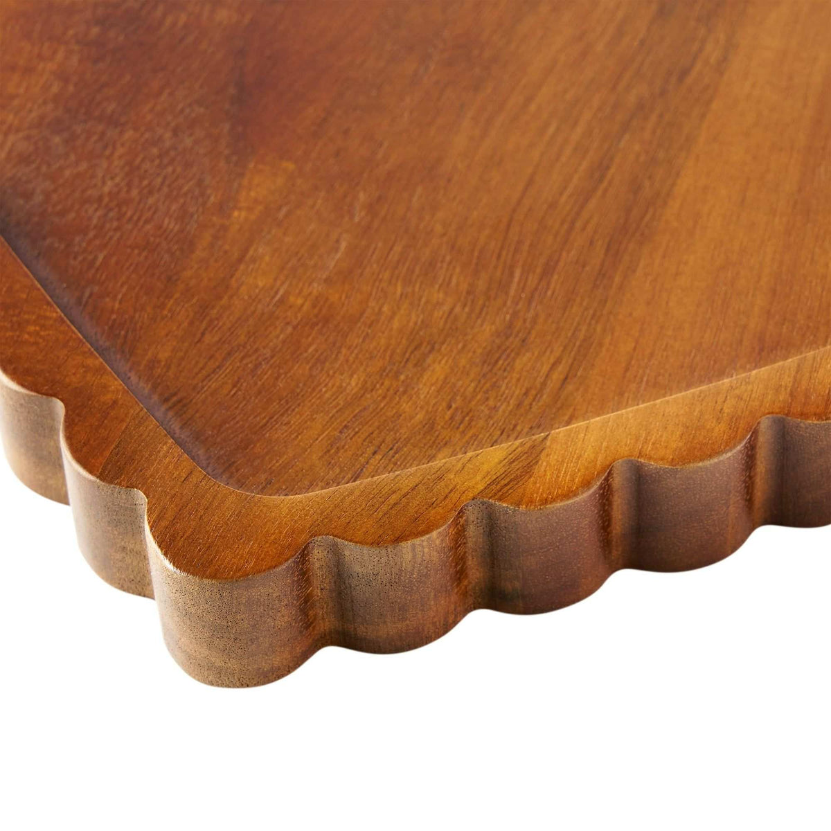 Close-up of the scalloped edge and rounded rim on an acacia heart serving tray — Serein Home