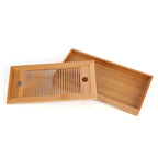 Bamboo tea tray with the slatted top lifted off the drip base