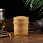 Mini bamboo tea canister, 8 cm tall with two bands, beside a teapot and loose tea, Serein Home