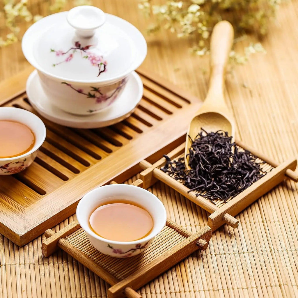Bamboo cup mat under a gongfu tea cup, beside a gaiwan and loose black tea, Serein Home