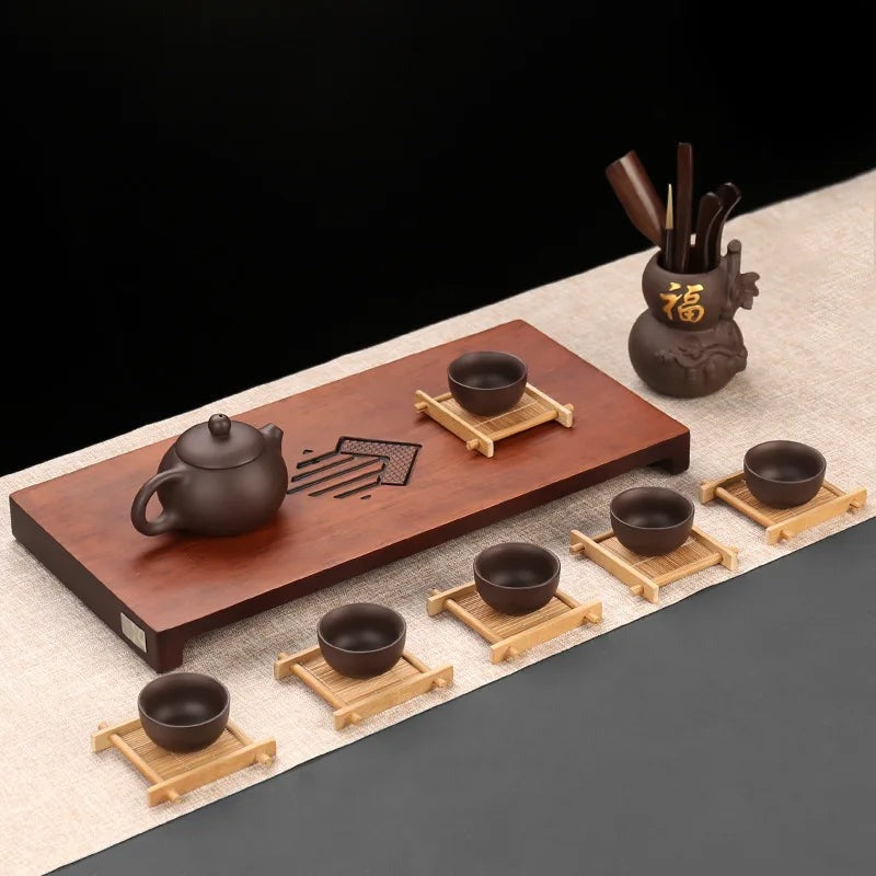 Small clay tea cups on bamboo cup mats beside a wooden gongfu tea tray, Serein Home