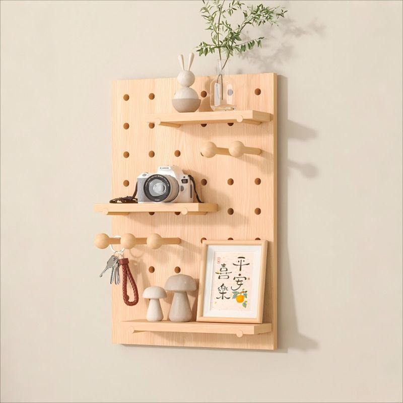 Wooden pegboard with shelves and hooks on a beige wall