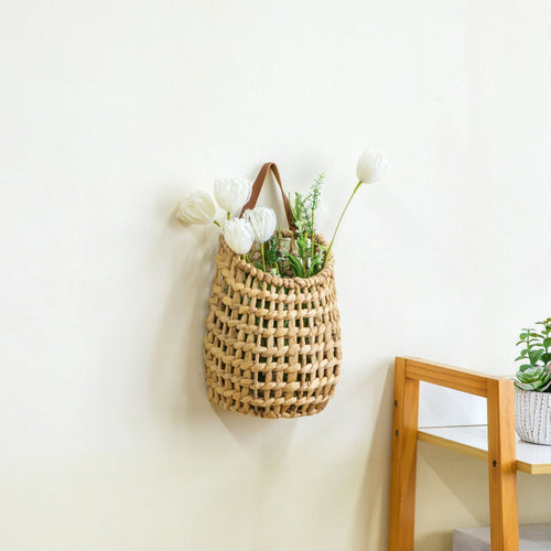 Woven hanging basket with dried stems, shown on a wall — Serein Home