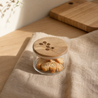 Leafy twig glass storage jar with engraved wooden lid on linen cloth - artisan kitchen canister - Serein Home