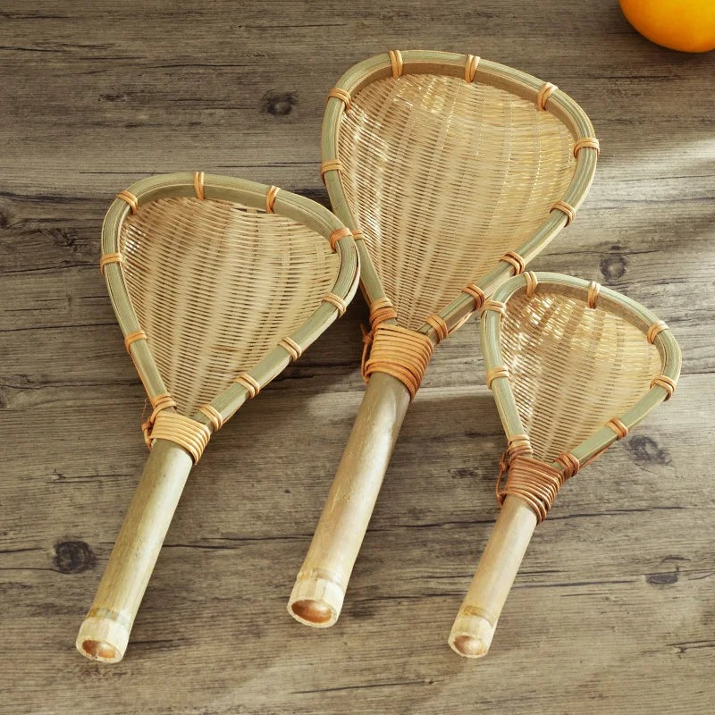 Three handwoven bamboo strainers in small, medium and large on a weathered wood table, Serein Home