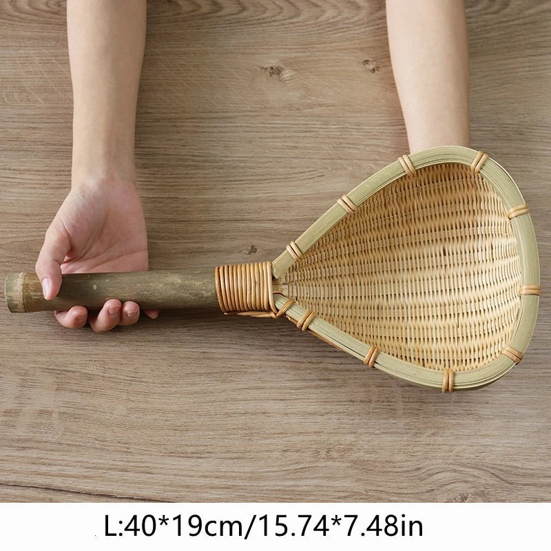 Large 40 cm handwoven bamboo strainer held by its bamboo handle, Serein Home