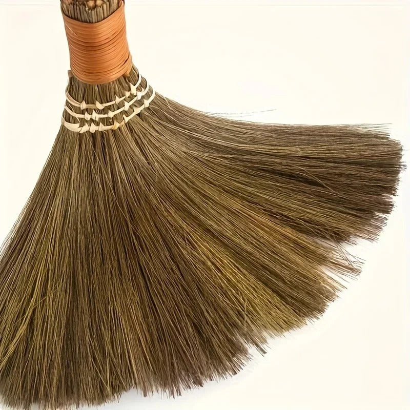 Close view of the fanned bristles of a handwoven grass broom