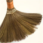 Close view of the fanned bristles of a handwoven grass broom