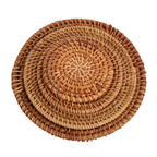 Set of four handwoven rattan coasters stacked by size, from 3.1 to 6.3 inches