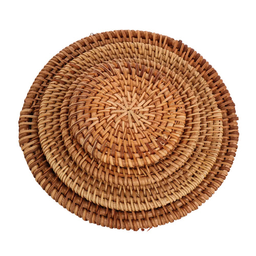 Set of four handwoven rattan coasters stacked by size, from 3.1 to 6.3 inches