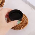Handwoven rattan coaster showing tight flat weave texture and natural color