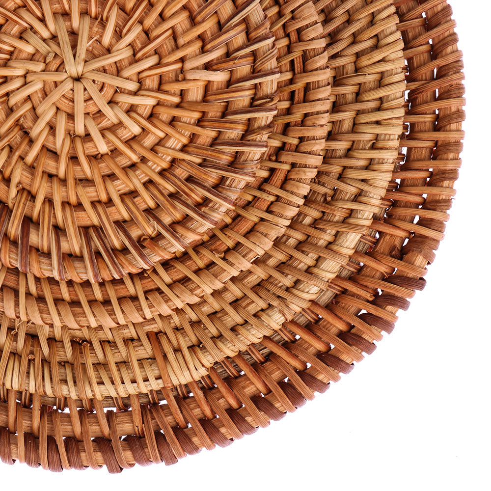 Close-up of handwoven rattan coaster showing tight flat weave texture and natural color