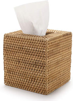 Natural handwoven rattan tissue box cover by Serein Home shown from a front three-quarter angle with a white facial tissue.