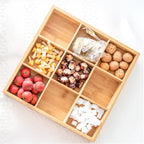 Nine-grid bamboo tray filled with nuts, dried fruit and sweets