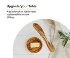 Olive wood butter spreader being used to spread butter on toast