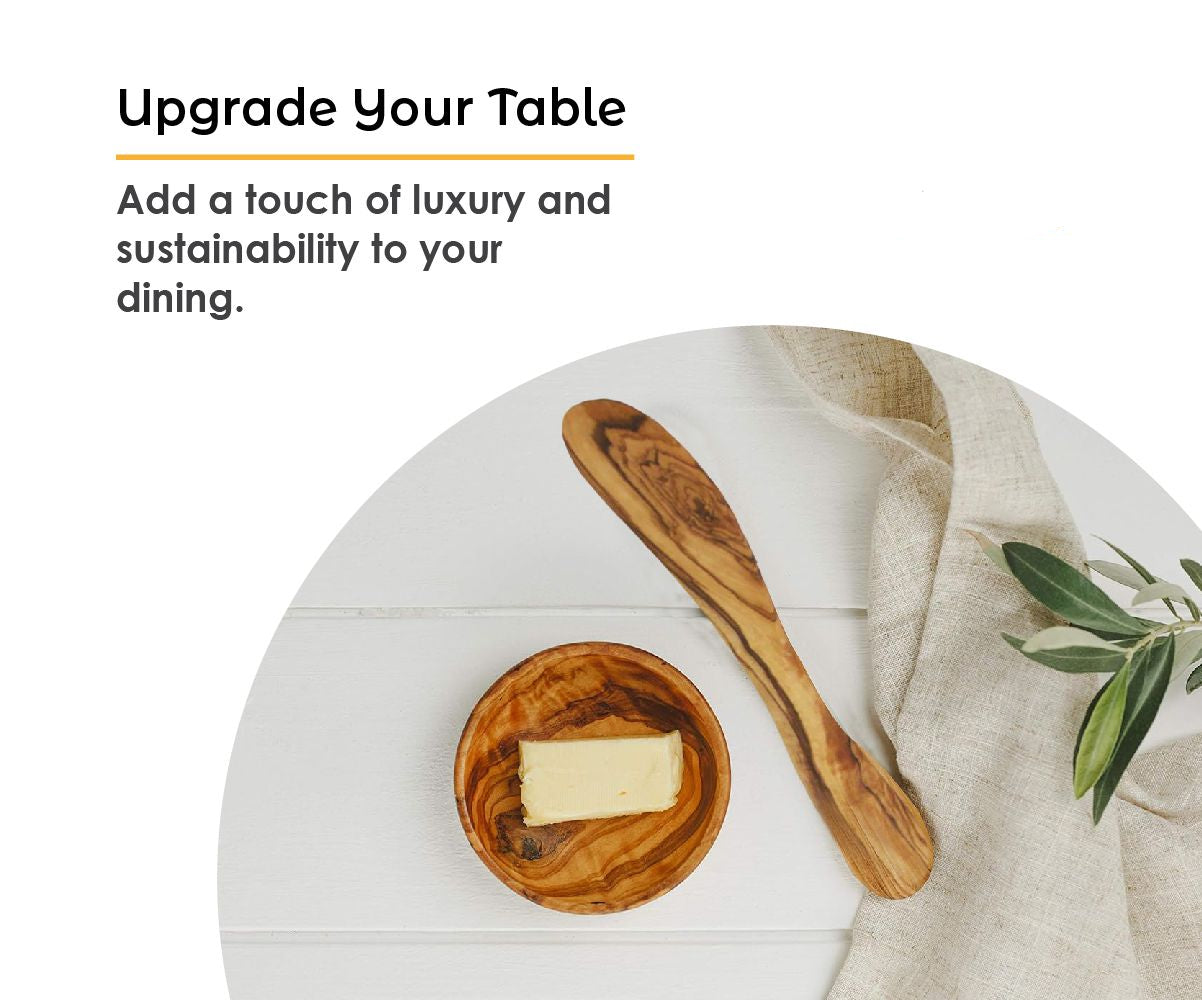 Olive wood butter spreader being used to spread butter on toast