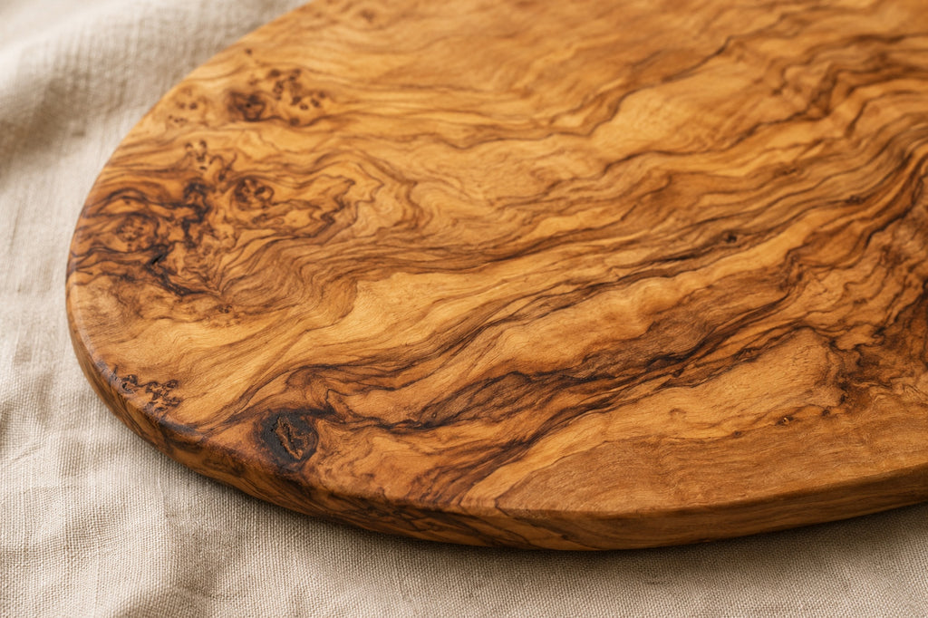 Close-up of natural olive wood grain on handcrafted kitchen set.