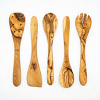 Five piece olive wood kitchen utensil set with spoons, spork, and spatula.
