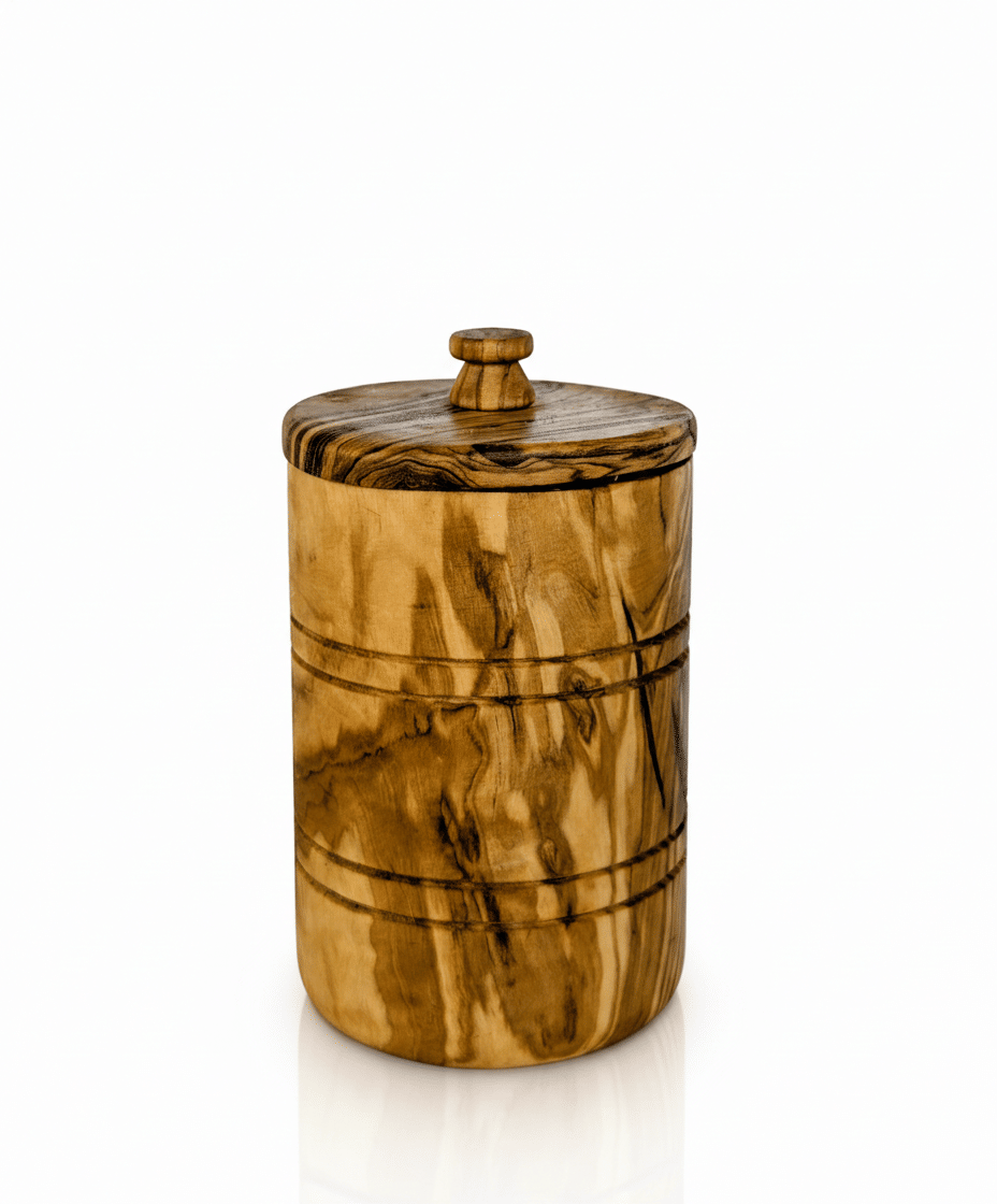 Handcrafted olive wood salt keeper with lid on white background showing natural wood grain