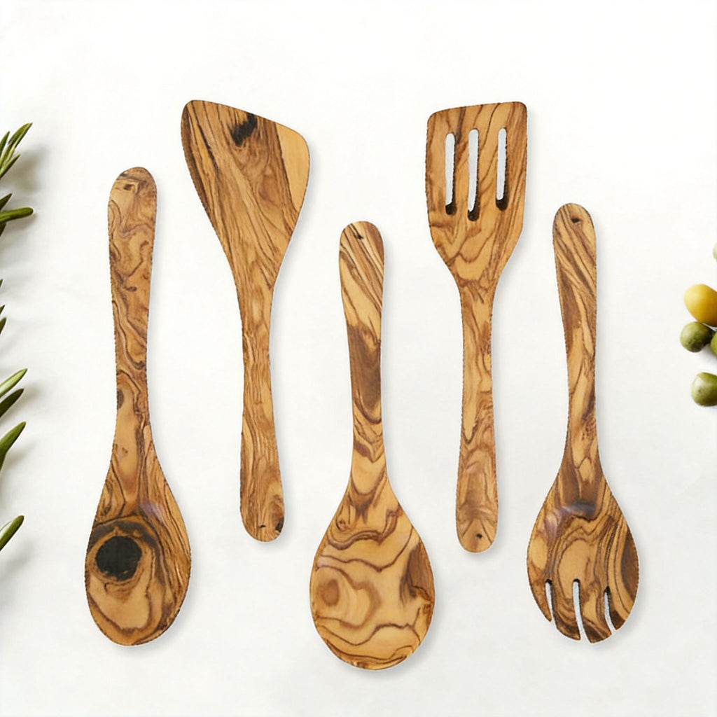 Olive wood spoon and spatula set arranged flat to show each utensil shape.