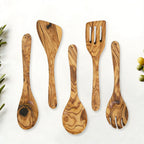 Olive wood spoon and spatula set arranged flat to show each utensil shape.