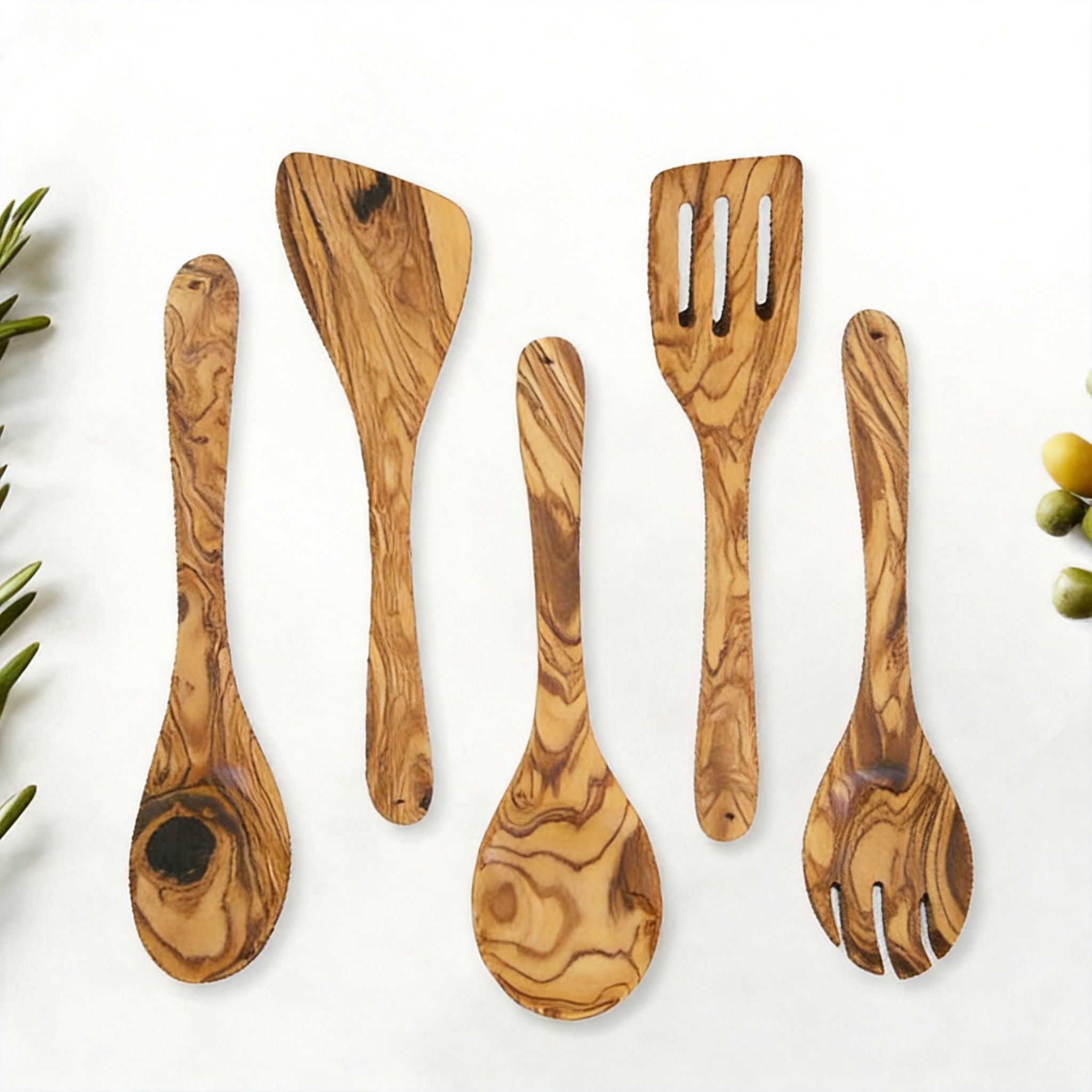 Olive wood spoon and spatula set arranged flat to show each utensil shape.