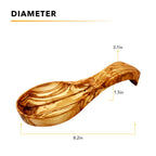 Close up of handcrafted olive wood spoon rest showing natural wood texture