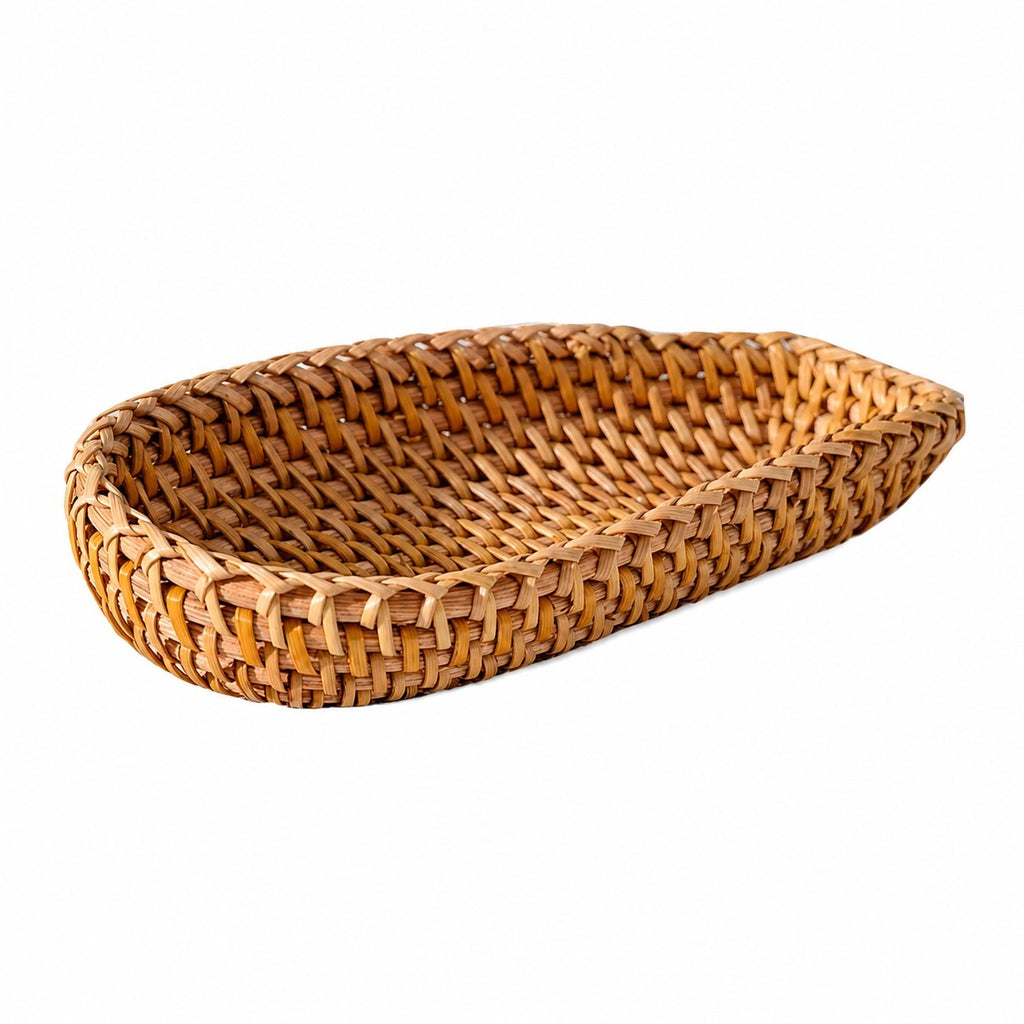 Small oval handwoven wild rattan tray showing natural weave texture, white background