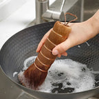 Hand scrubbing a soapy carbon steel wok with a copper-wire-bound palm brush, Serein Home