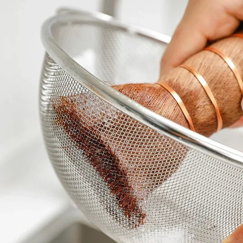 Palm pot brush scrubbing the inside of a stainless steel mesh colander, Serein Home