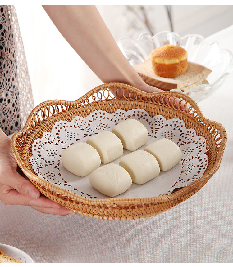 Overhead view of handwoven natural rattan scalloped tray showing full shape and pattern