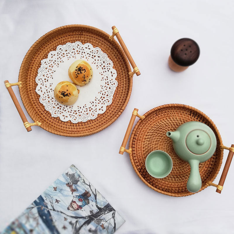 Close-up of bamboo handle and natural rattan weave detail on round serving tray