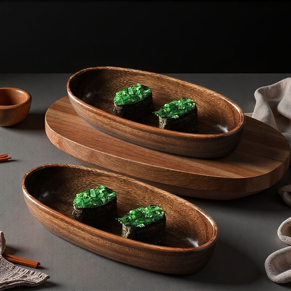 Two walnut sushi boat plates with nori rolls on a dark tabletop