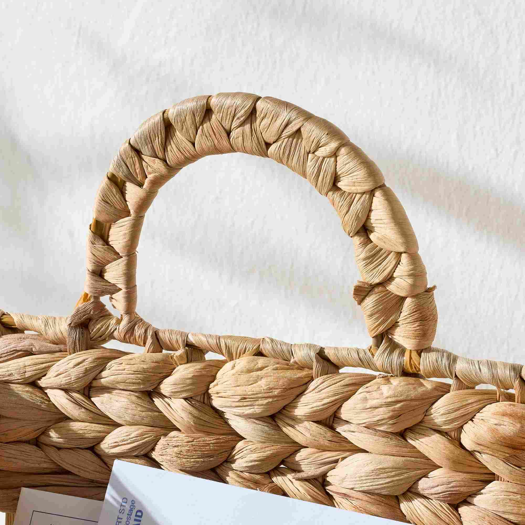Close-up of water hyacinth basket woven loop handle — top grip detail, natural fiber construction, Serein Home