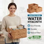 Person holding a woven water hyacinth storage basket filled with books in a bright home interior