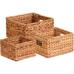 Set of 3 woven water hyacinth storage baskets in graduated sizes, natural finish, white background