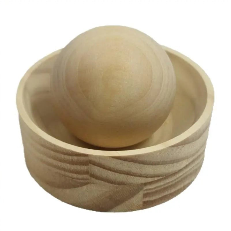Wooden dumpling press cup with its wooden ball resting inside, on a plain white background, Serein Home