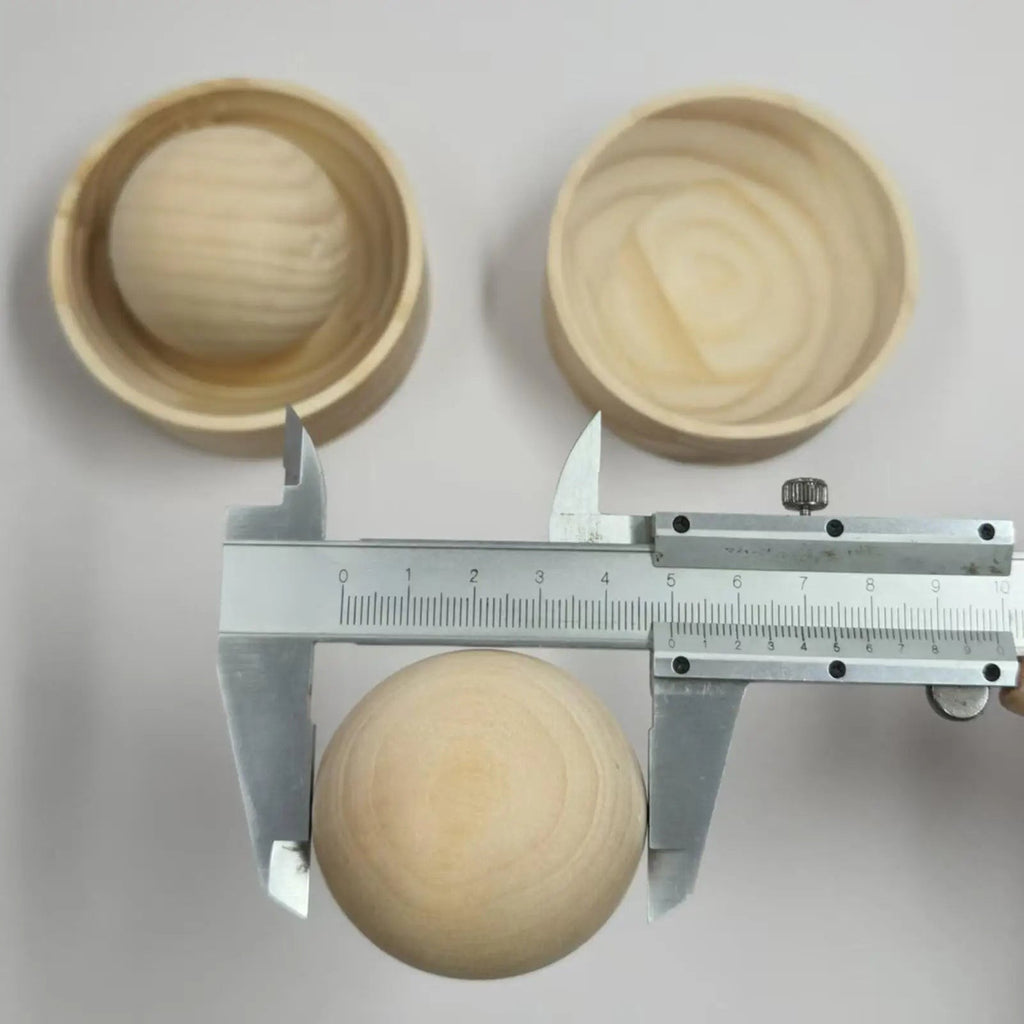 Wooden press ball measured with a steel caliper beside two empty wooden press cups, Serein Home
