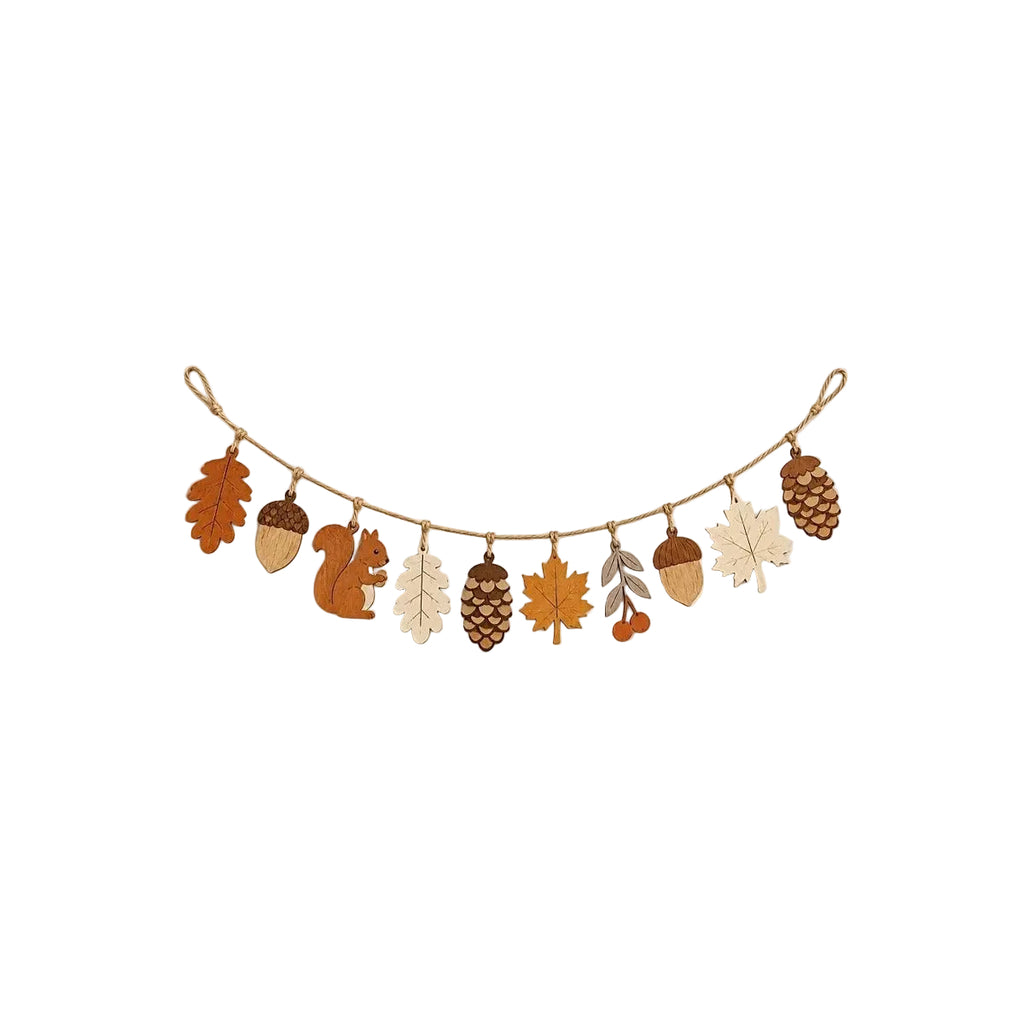 Wooden fall leaf garland with ten stained pendants strung on jute rope against a cream wall