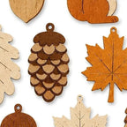 Close view of the layered pinecone and maple leaf pendants, wood grain showing through the stain