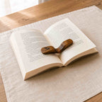 Close-up of the curved wood grain and engraved bird motif on the Serein Home thumb page holder