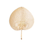 Heart-shaped woven palm leaf hand fan on a white background