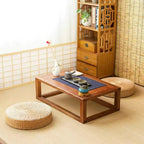 Straw floor cushions beside a low wooden tea table with a tea set, Serein Home