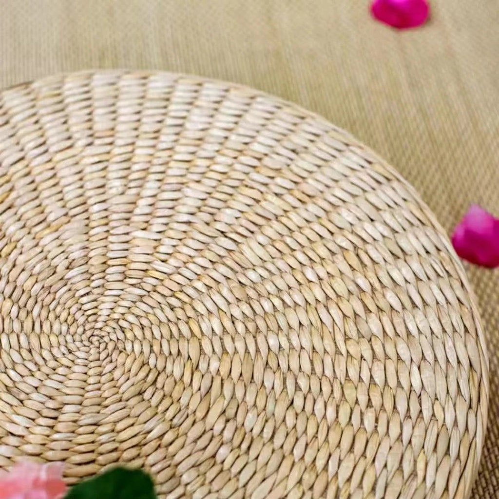 Close-up of the hand-coiled straw top of a round floor cushion, Serein Home