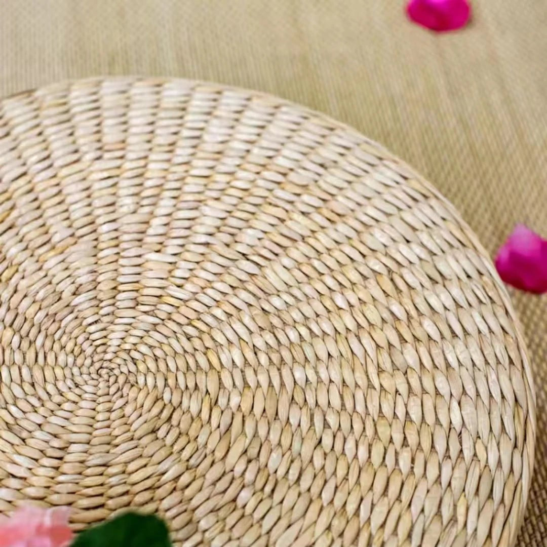 Close-up of the hand-coiled straw top of a round floor cushion, Serein Home